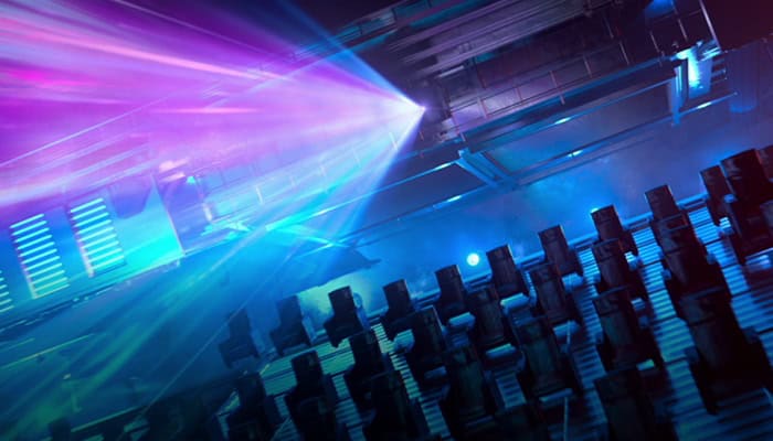 Projector light over auditorium representing immersive design